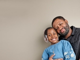 Father and daughter hugging and smiling