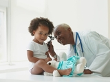 physician examining patient's ear