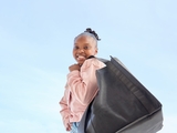 Smiling CHOP patient holding shopping bag