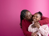 Mother hugging daughter