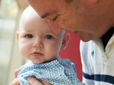 Dad smiling hugging young child