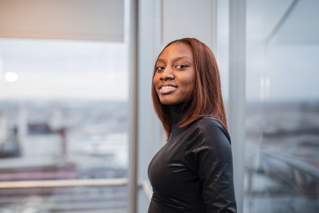 Female young adult looking confident in front of office window