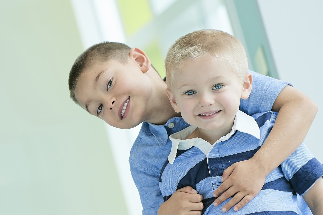 Older brother hugging his younger brother