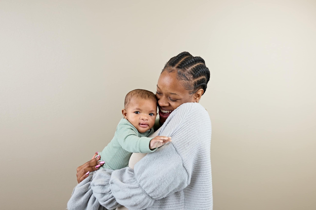 Mother holding her baby smiling