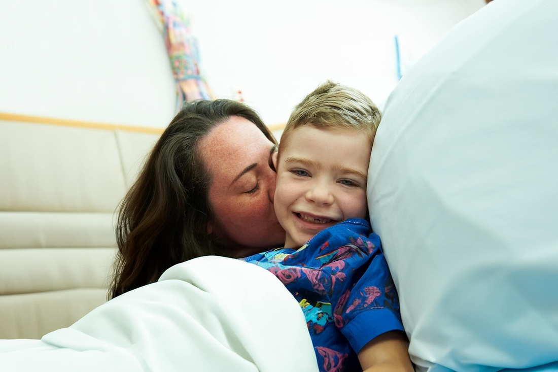 Mother kissing her inpatient son