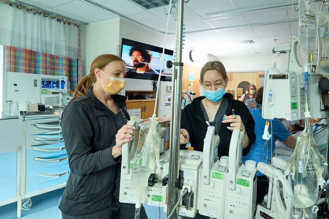 Two nurses monitoring critical equipment