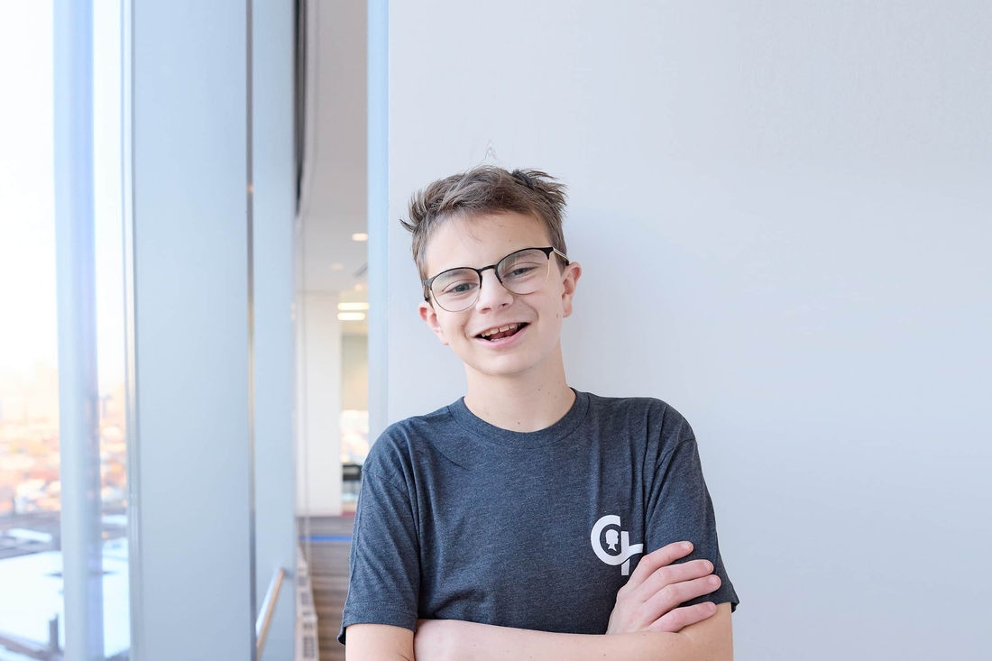 Teen standing against the wall with arms crossed