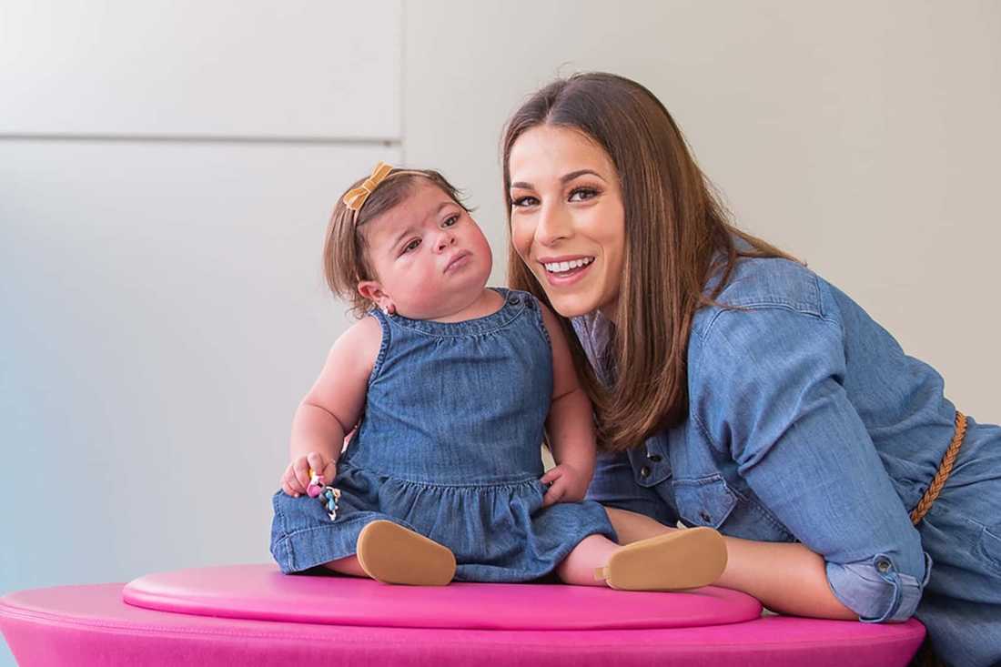 Mother leaning in to her infant daughter