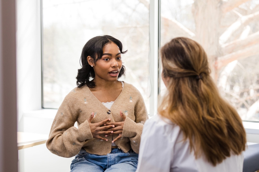 Teen girl talking with a member of the hospital staff