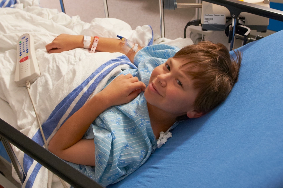 Teen boy on transport bed