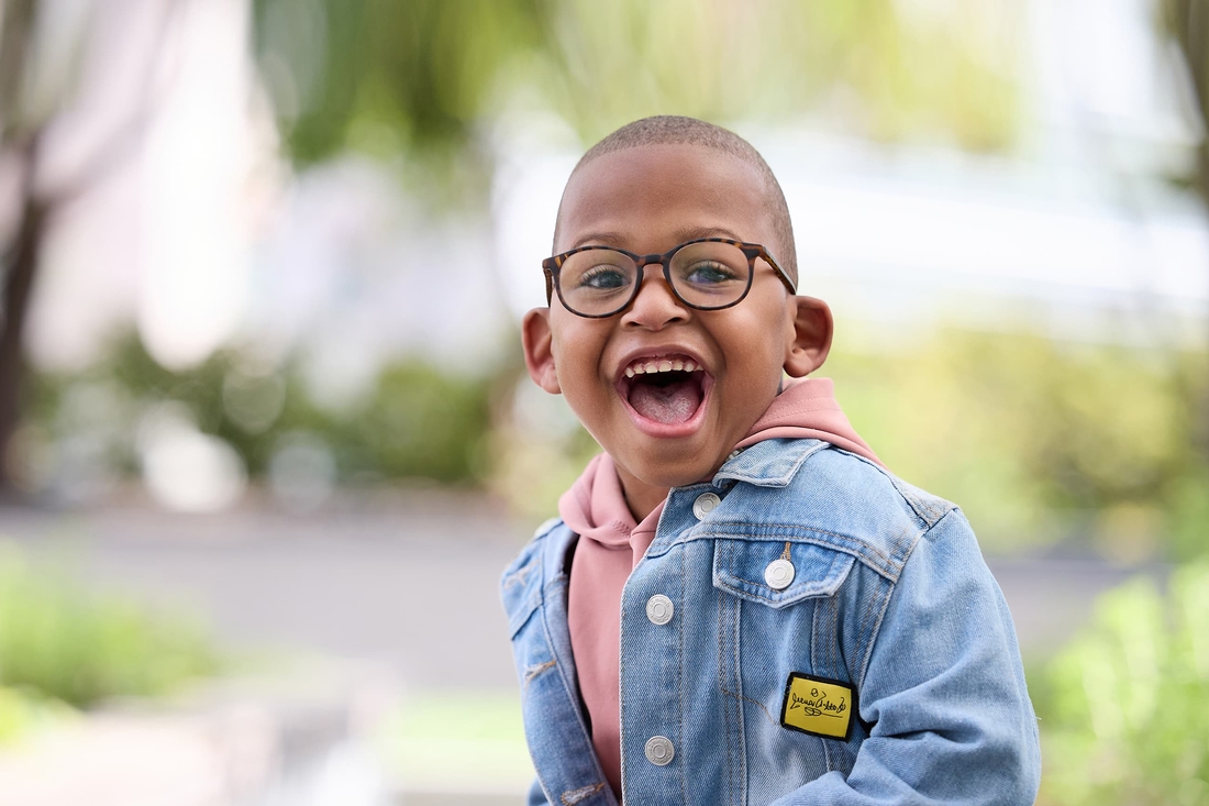 Boy smiling in the hospital garden.