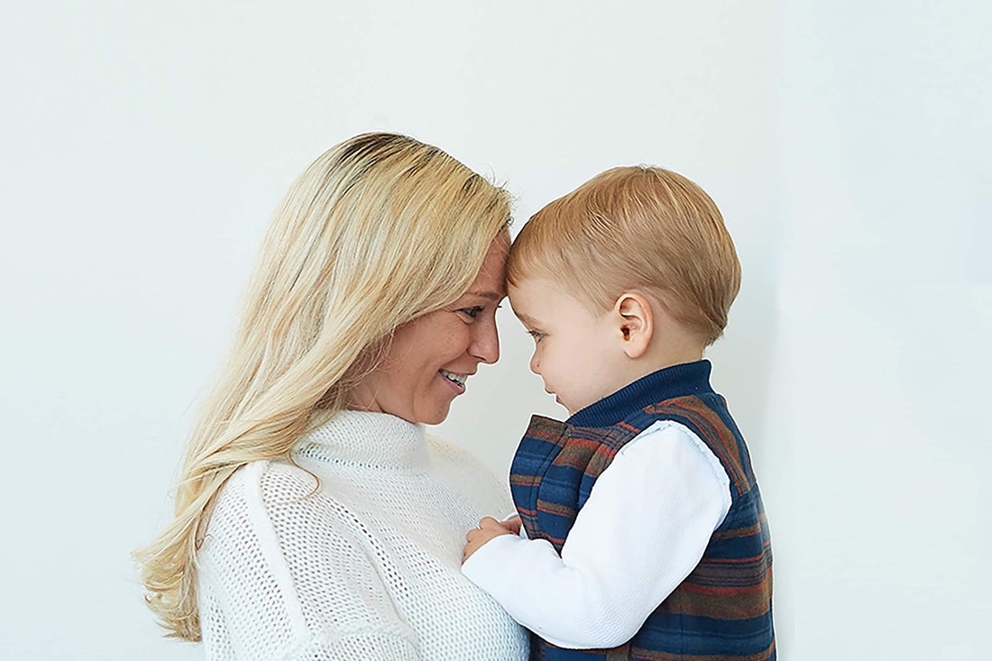 Mother and son touching foreheads