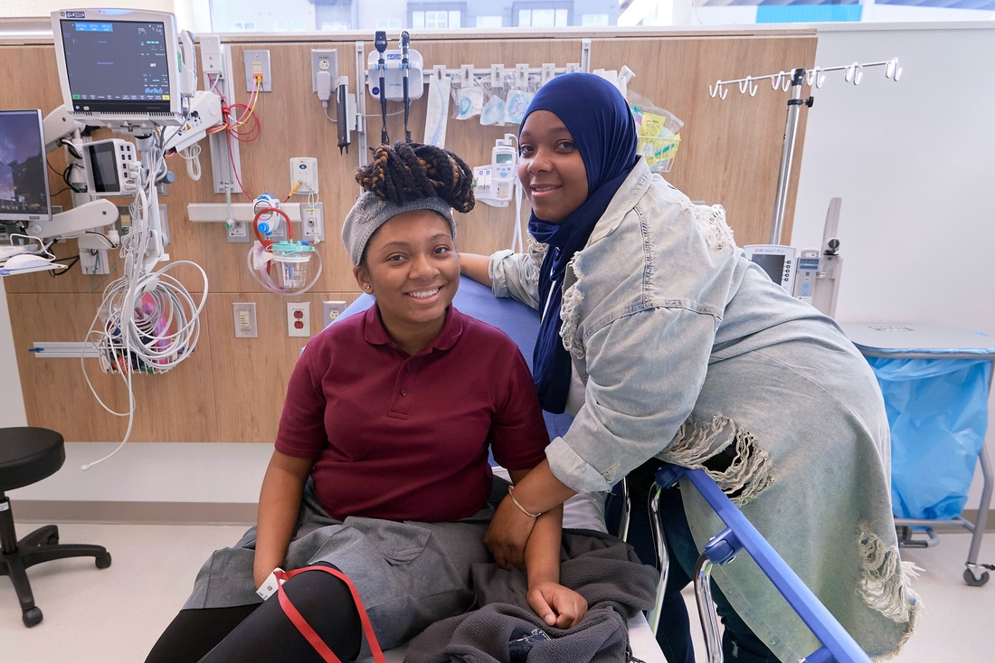 Teen girl with her mother at Pediatric Hospital posing on hospital bed
