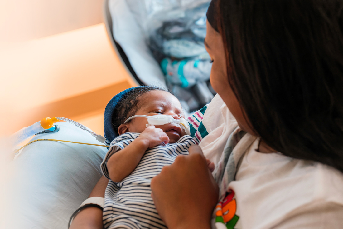 Mommy holding her baby a with a complex medical condition