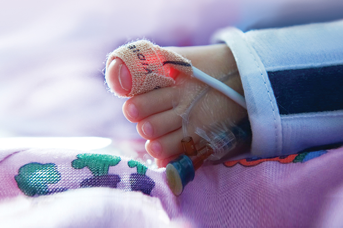 Close-up of a newborns foot with monitoring device wrapped around a not so big, big toe