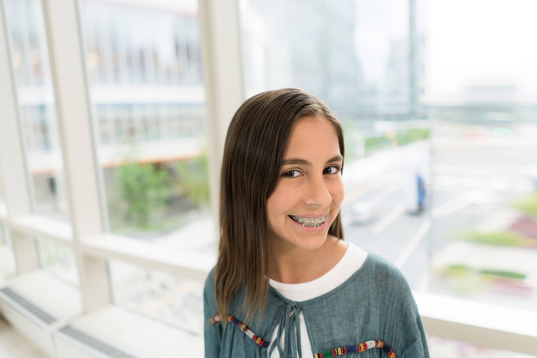 Young teen in braces smiling