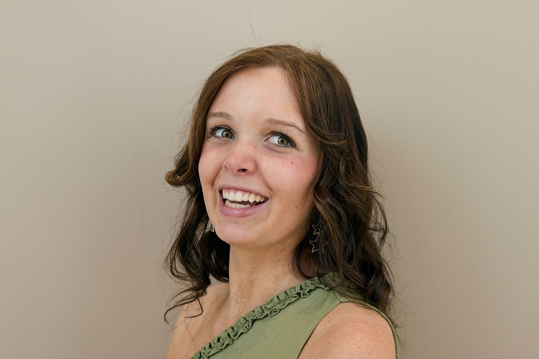 Teen girl cancer survivor wearing green dress.