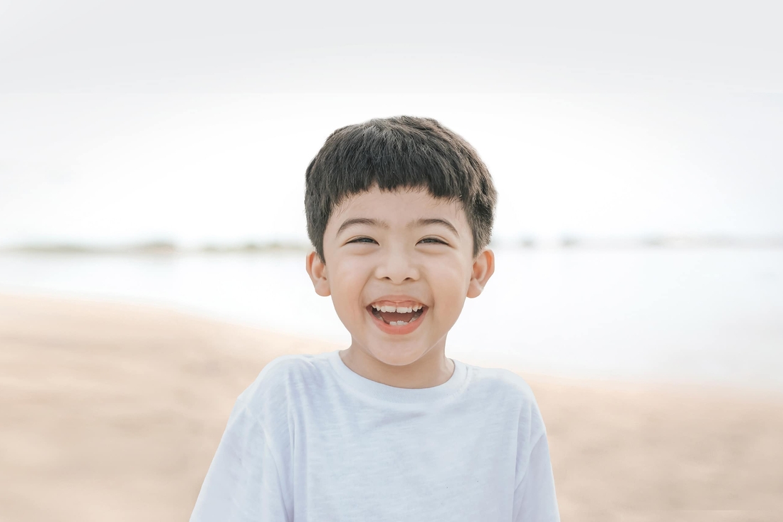 Young boy outside laughing