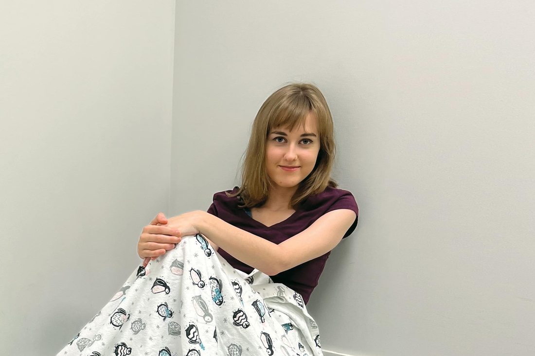 Teen sitting on exam table