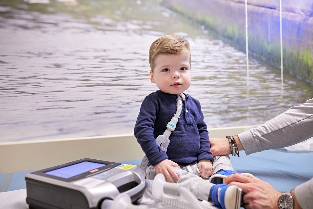 Young boy with epilepsy on exam table in doctor office.