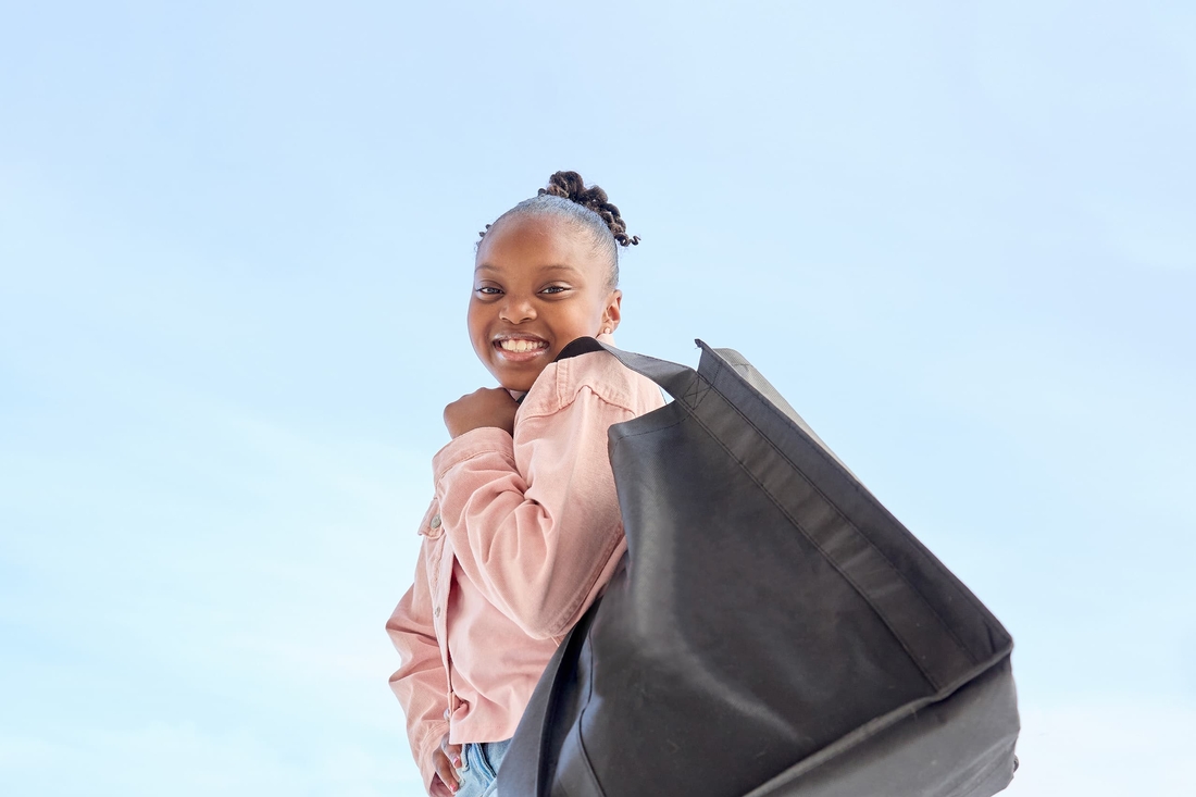 Smiling CHOP patient holding shopping bag