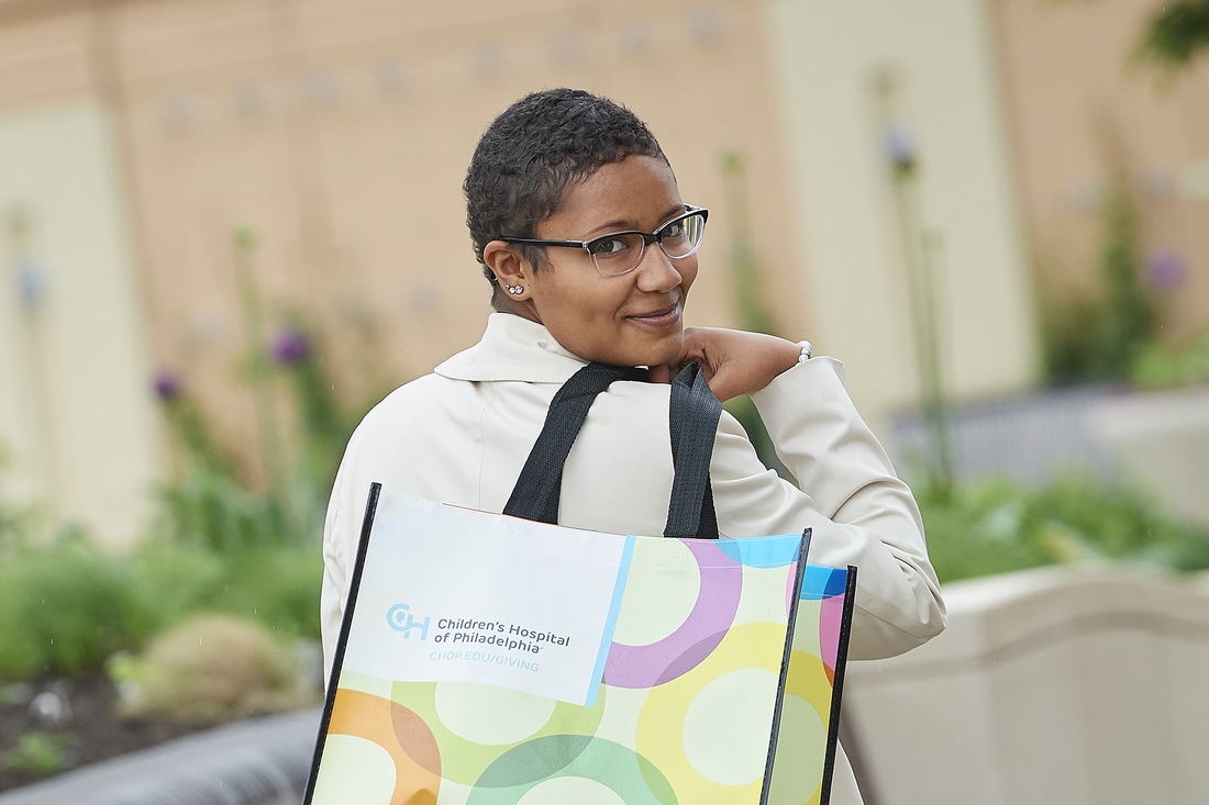 Teenaged CHOP patient holding shopping bag