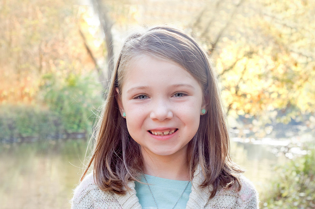 Young girl smiling at the camera.