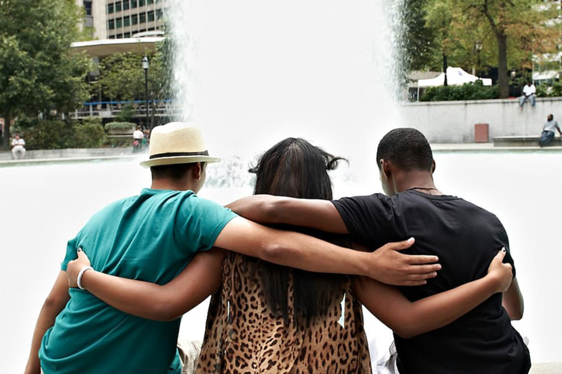 Three teens with arms around each other