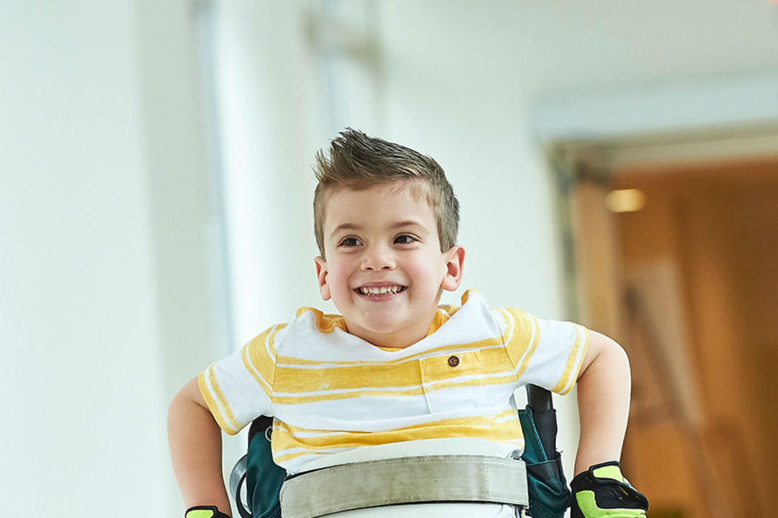 Young boy smiling in wheelchair