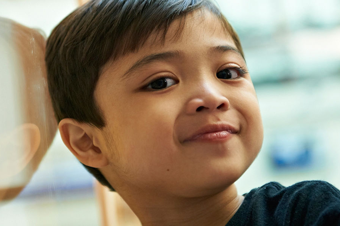 Little boy smiling at the camera.