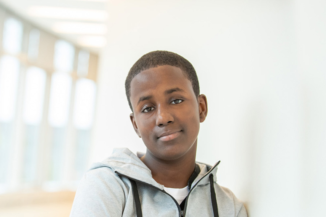 Teenage boy looking into the camera.