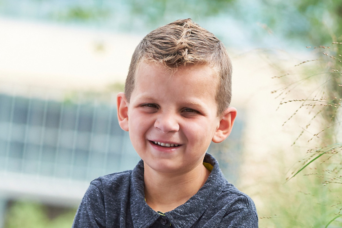 Little boy smiles at the camera.