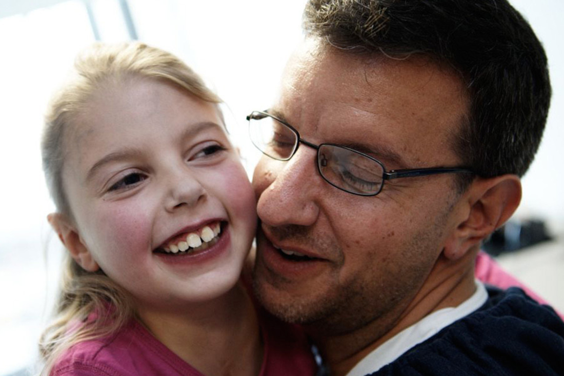Father holding his smiling daughter