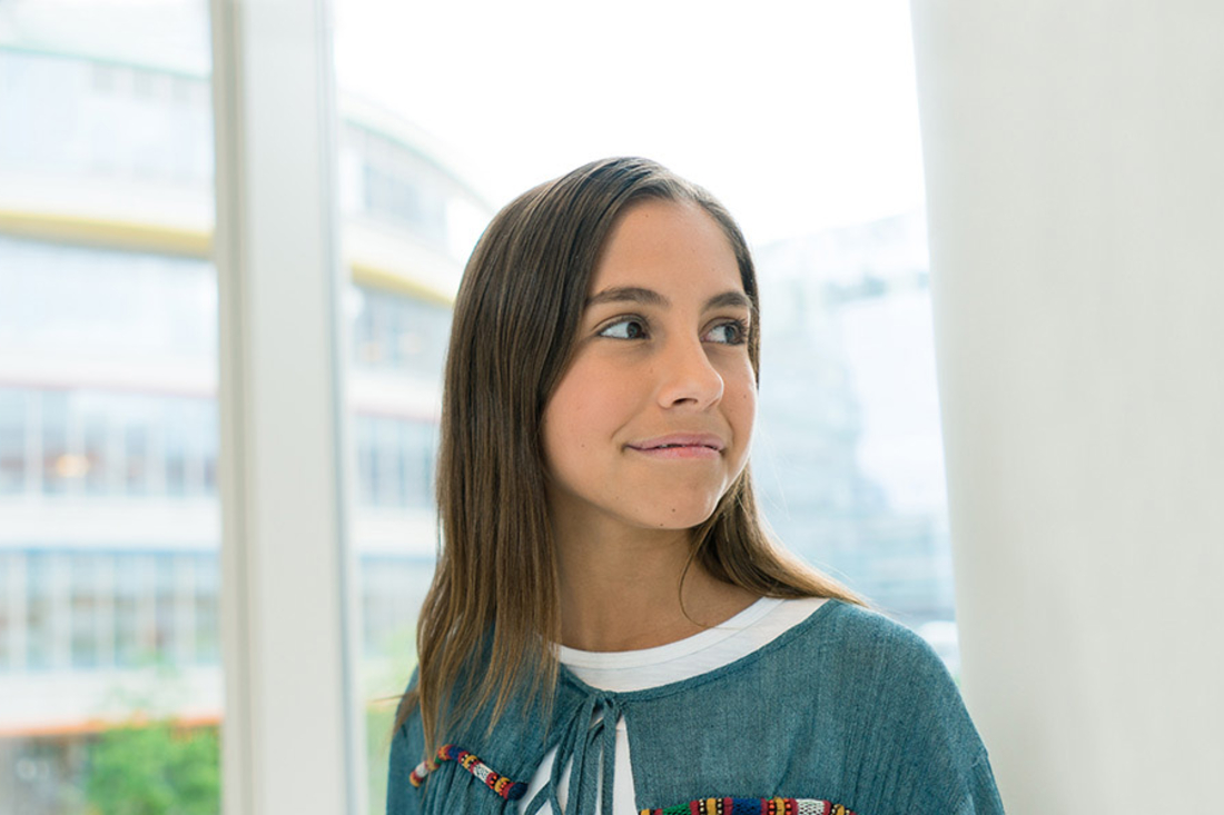young girl looking over her shoulder