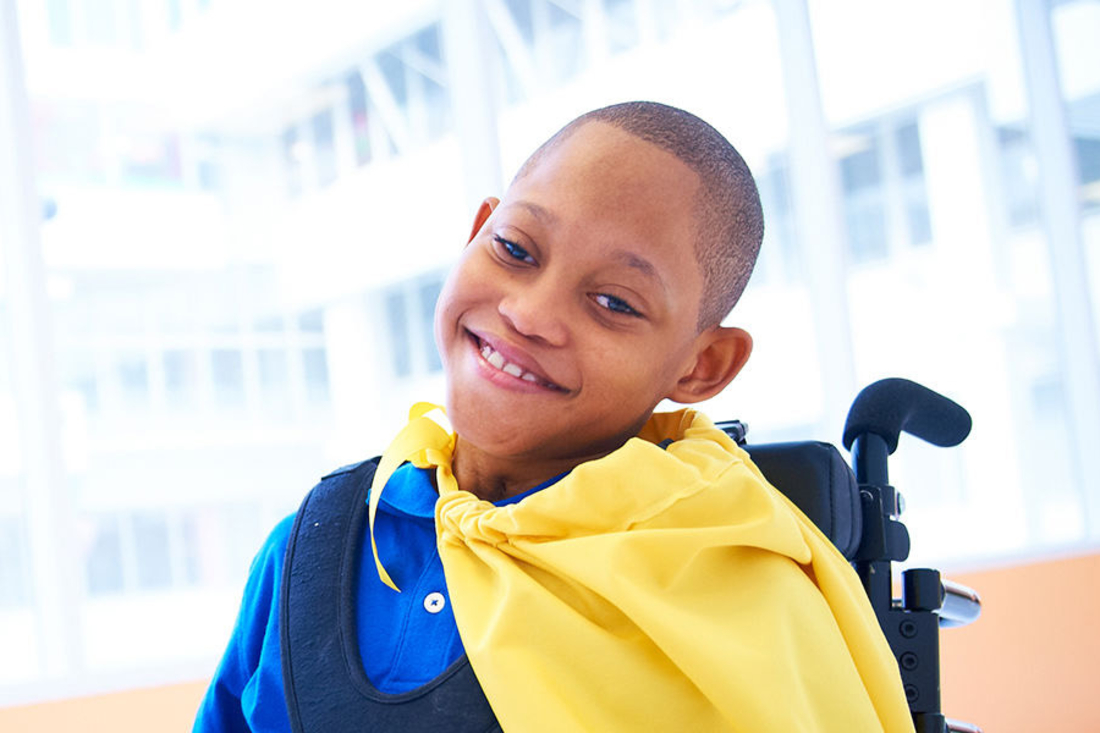 Cerebral Palsy patient smiling with his cape