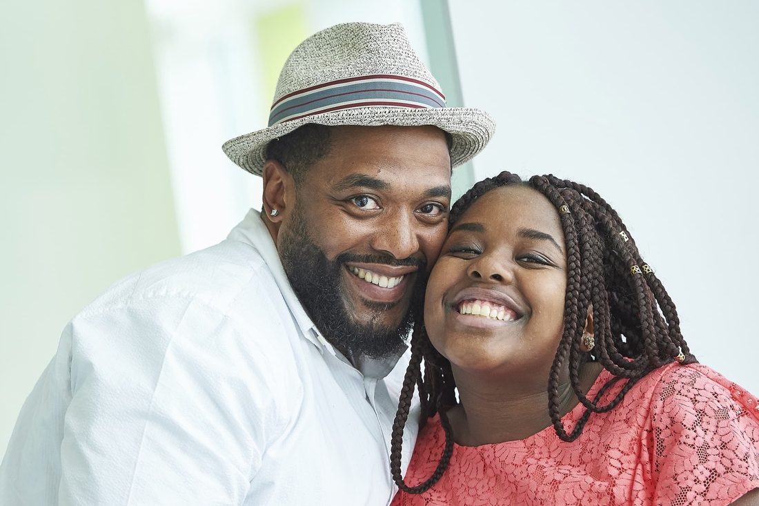 Father and daughter smiling together