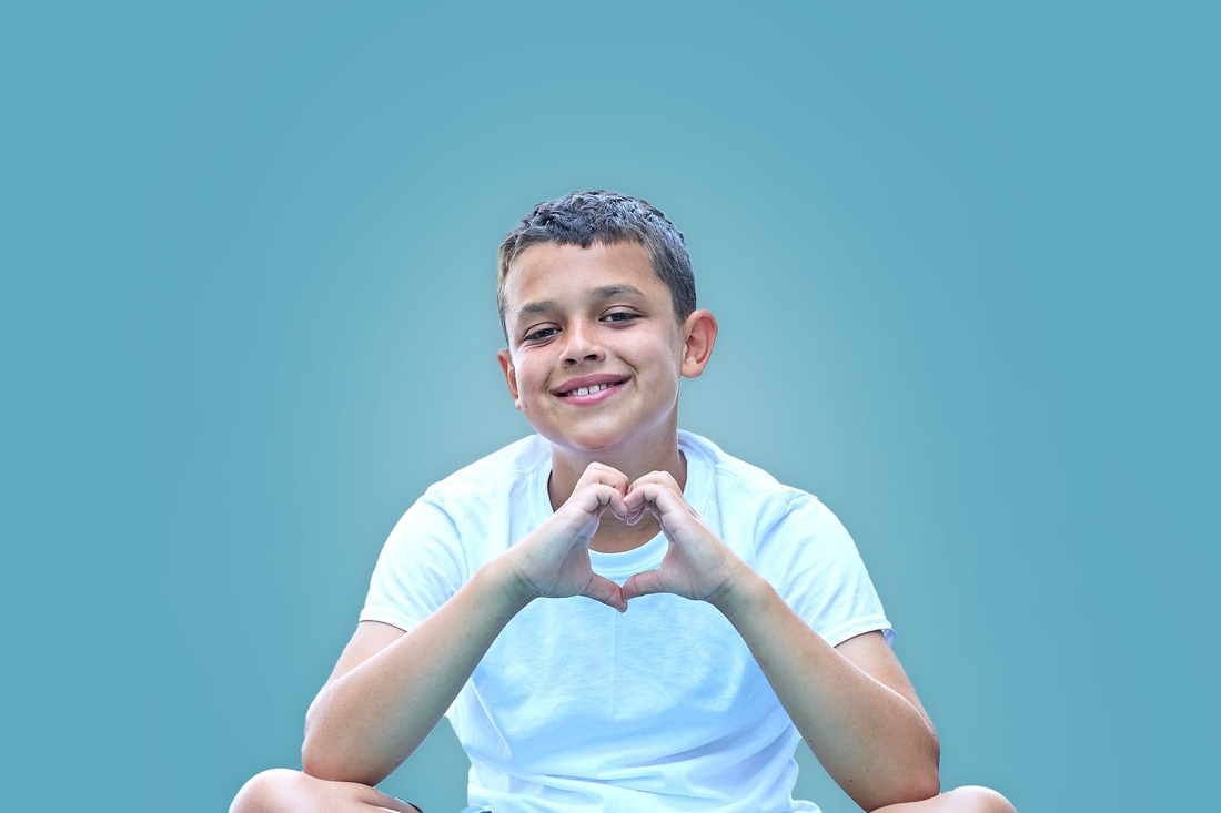 Mason, making a heart with his hands