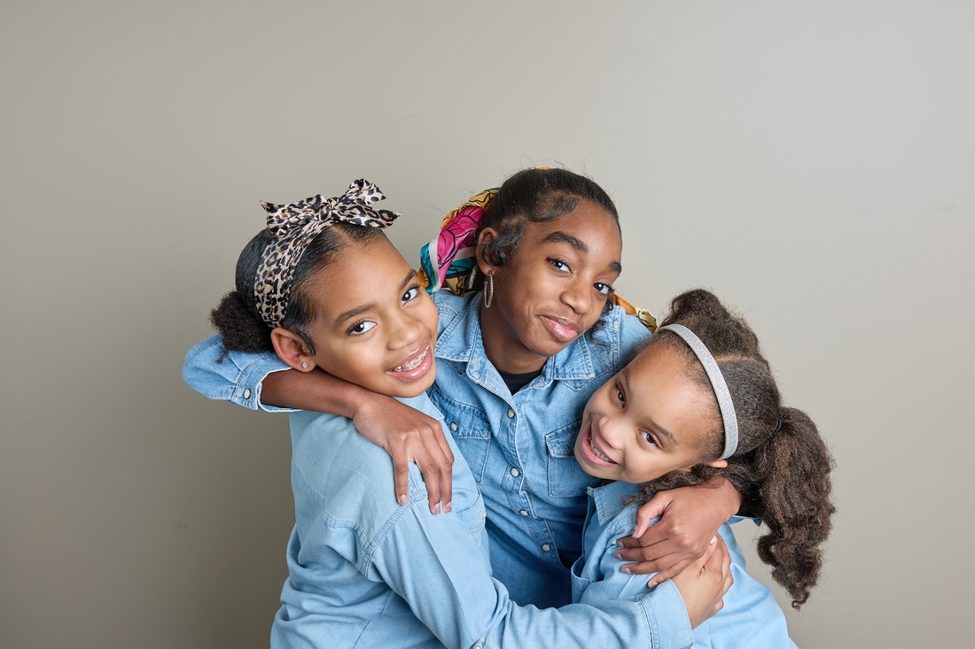 Three sisters hugging