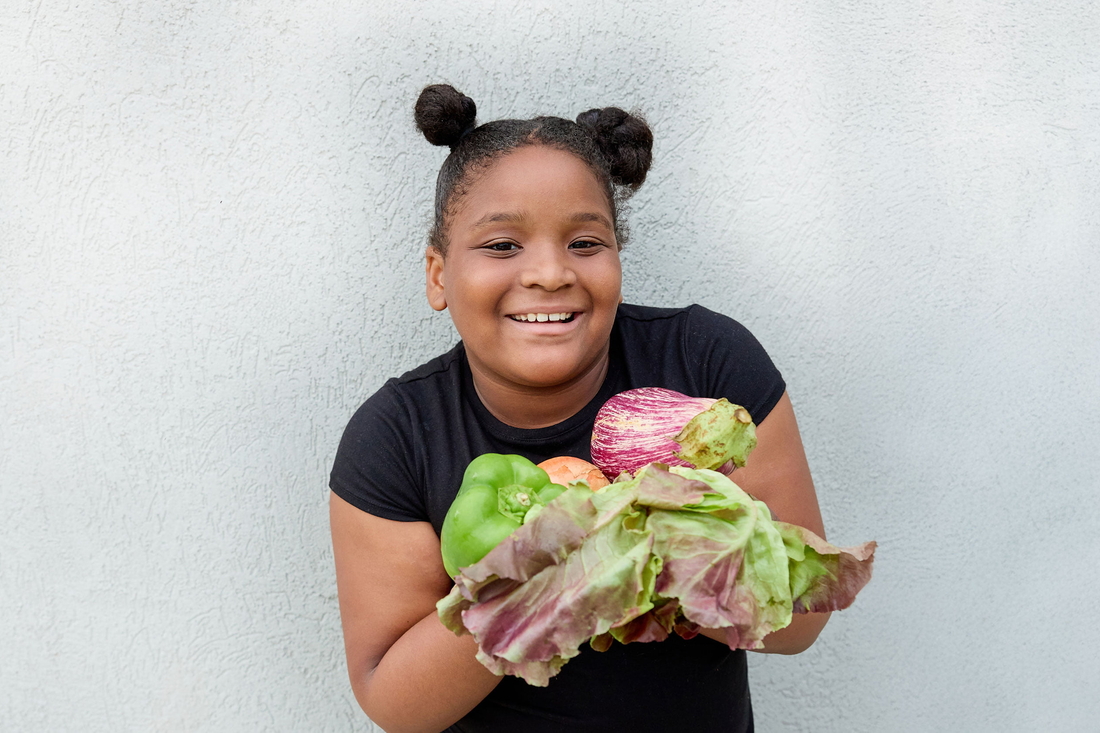 Young girl with food in her arms