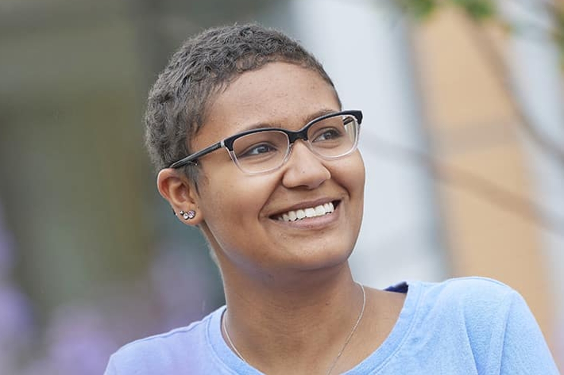 Teen girl smiling and looking in the distance