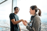 Young adult male interacting with femaie doctor in an office setting