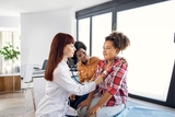Physician listening to heart of teen