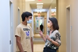 Young boy talks with a member of the hospital staff 