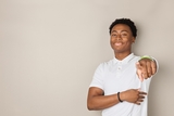 African american adolescent male smiling and pointing at the camera