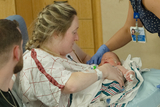 A nursing mother pumping breastmilk