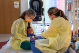 A baby charms staff members
