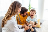 Little boy at doctor appointment with his dad.