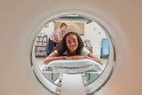 teen patien smiling while inside the MRI machine