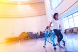 Teenage girl trains using a walker