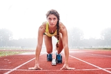 Teen girl athlete about to start a race.
